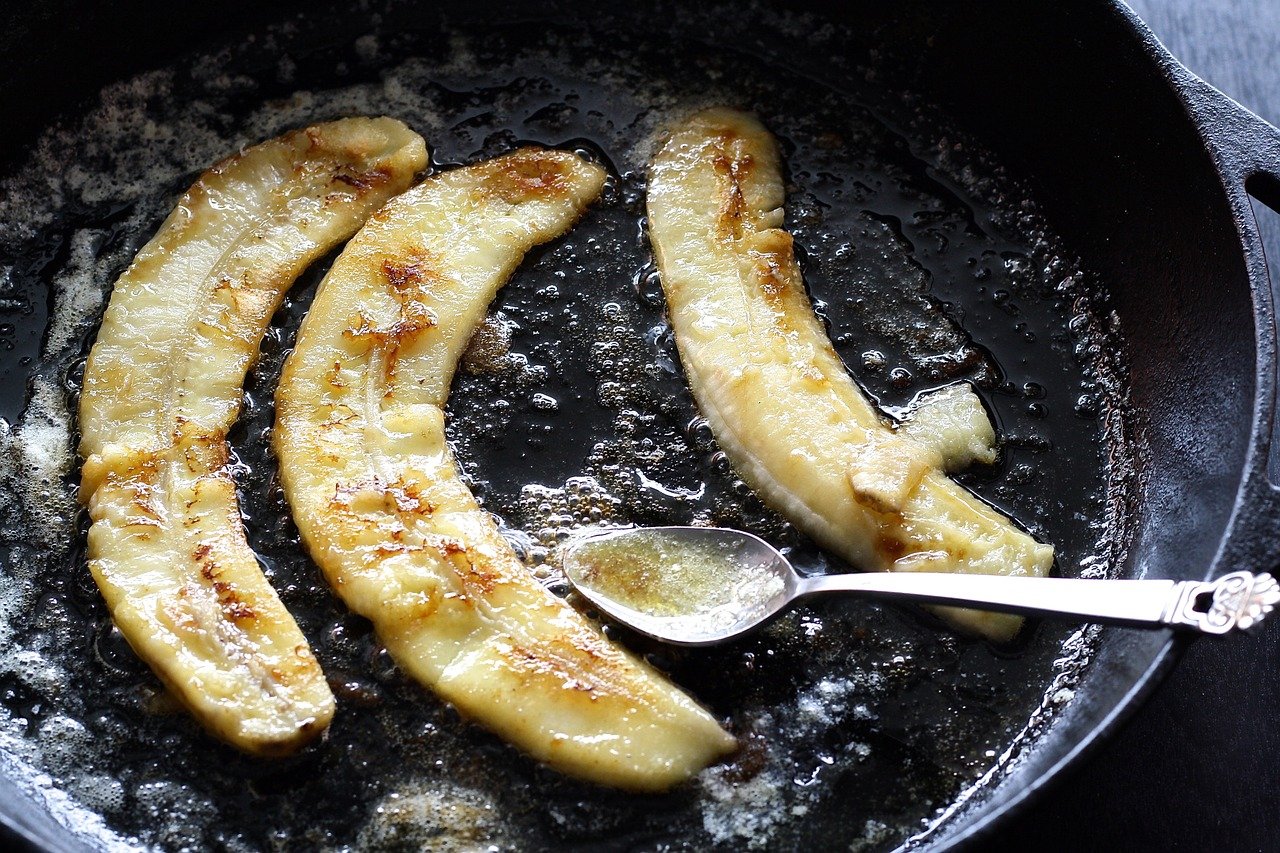caramelized banana and spoon in pan