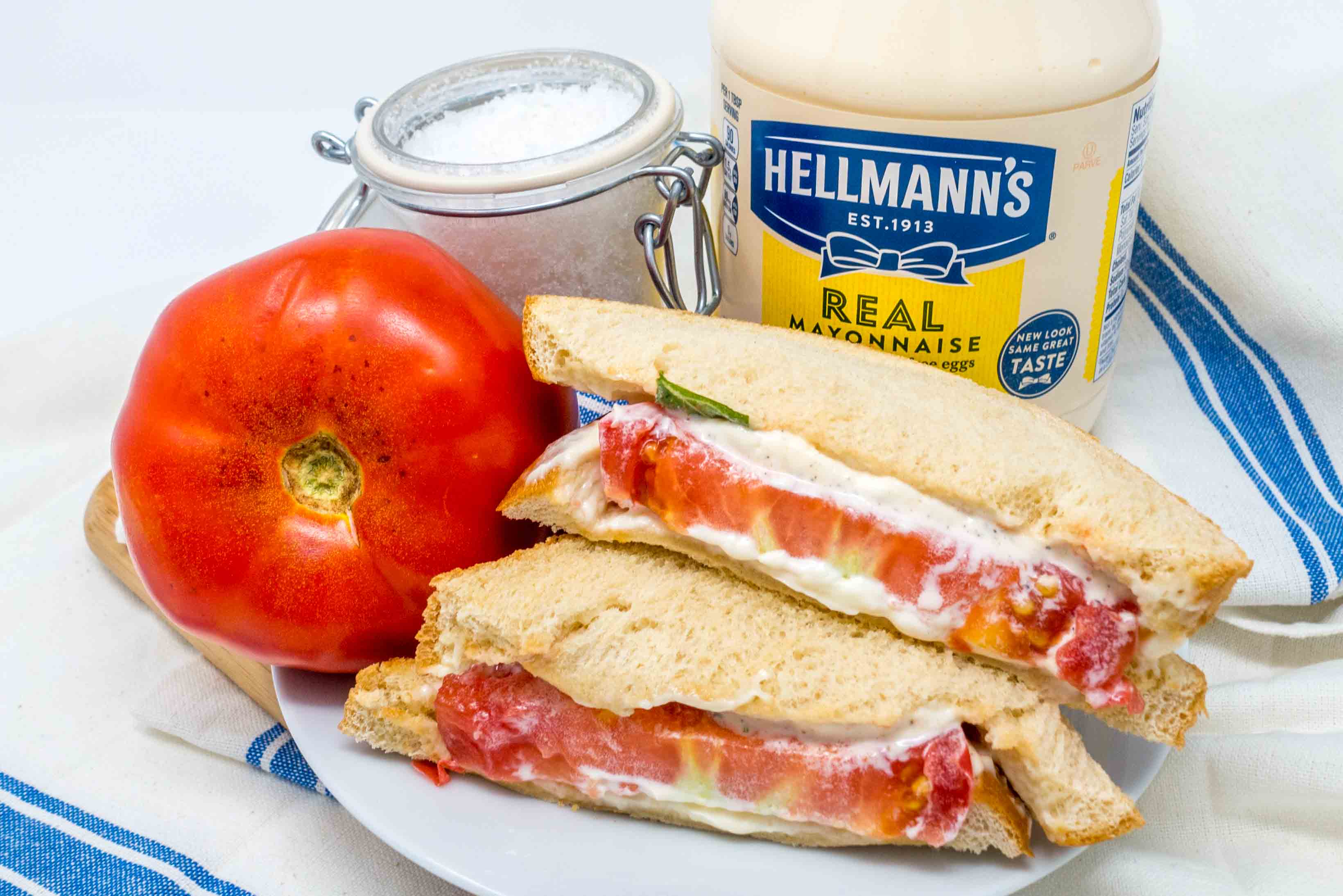 https://www.ibelieveicanfry.com/wp-content/uploads/2018/08/cut-southern-tomato-sandwich-salt-Hellmanns-mayonnaise.jpg