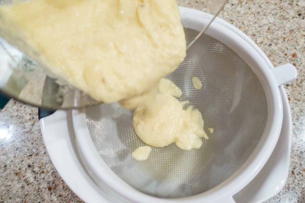 Strain the pineapple puree to separate the juice for the Hawaiian marinade