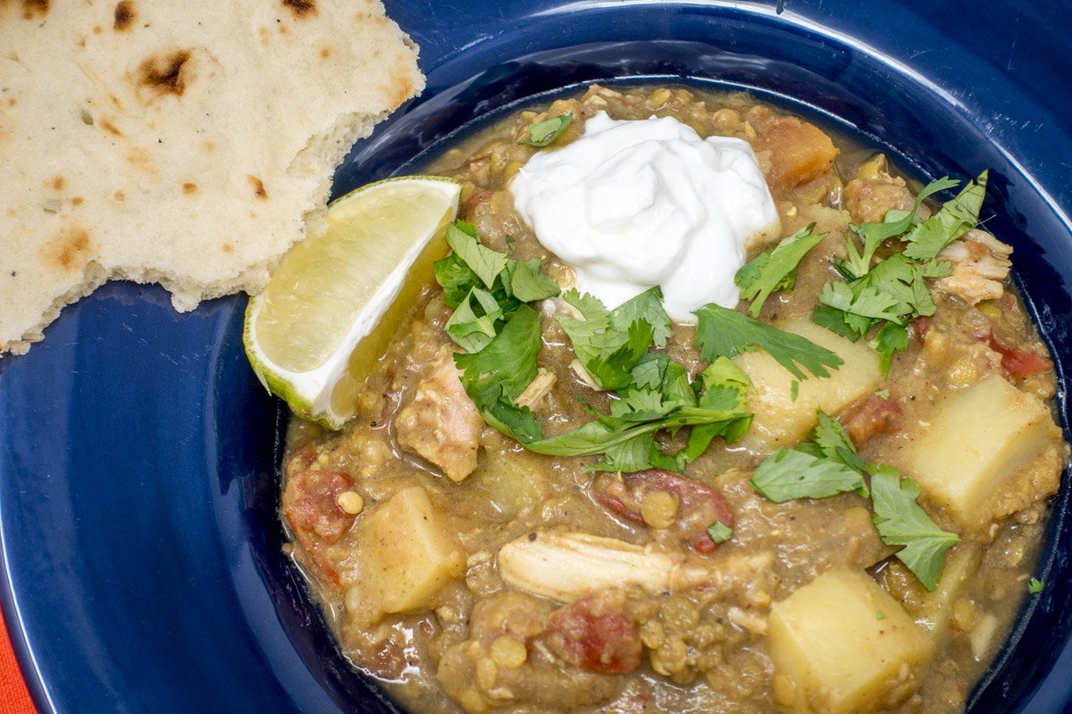 This curry chicken crock pot recipe is topped with cilantro, yogurt, and lime to add creaminess and acid