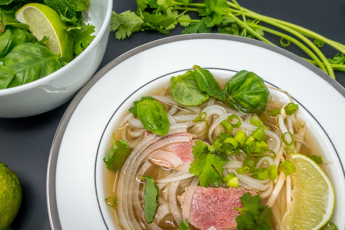 The best pho recipe includes flavorful broth, the perfect noodles, and lots of fresh herbs