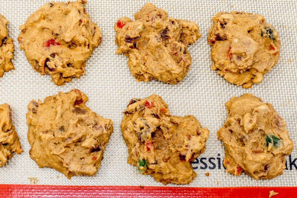Drop the candied fruit cake cookie batter onto a silicone baking sheet so it won't stick