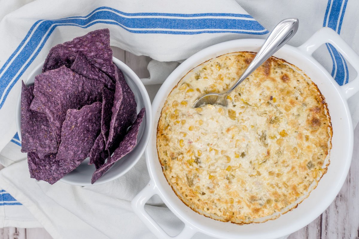 Serving the hot Mexican corn dip with tortilla chips, Fritos, or vegetables makes everyone happy