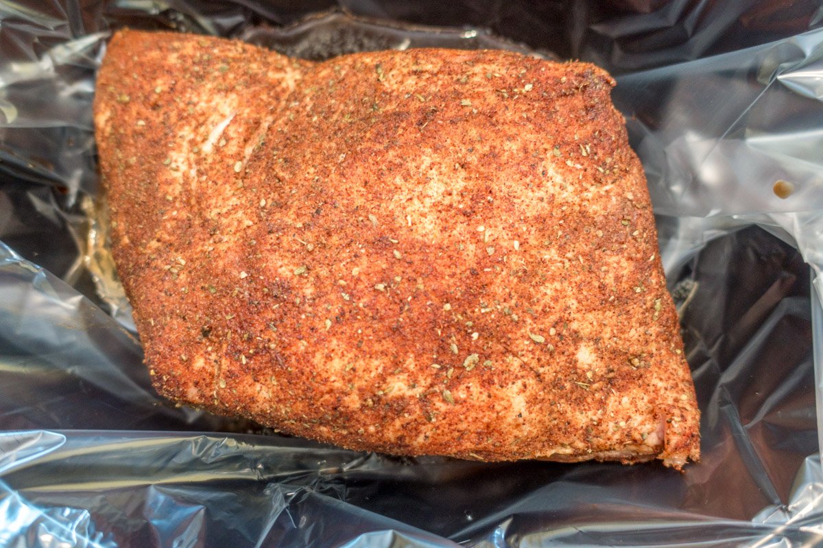 Pork butt rubbed with spices in slower cooker