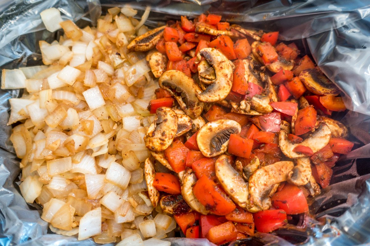 Cooked onions, mushrooms, and peppers in the slow cooker
