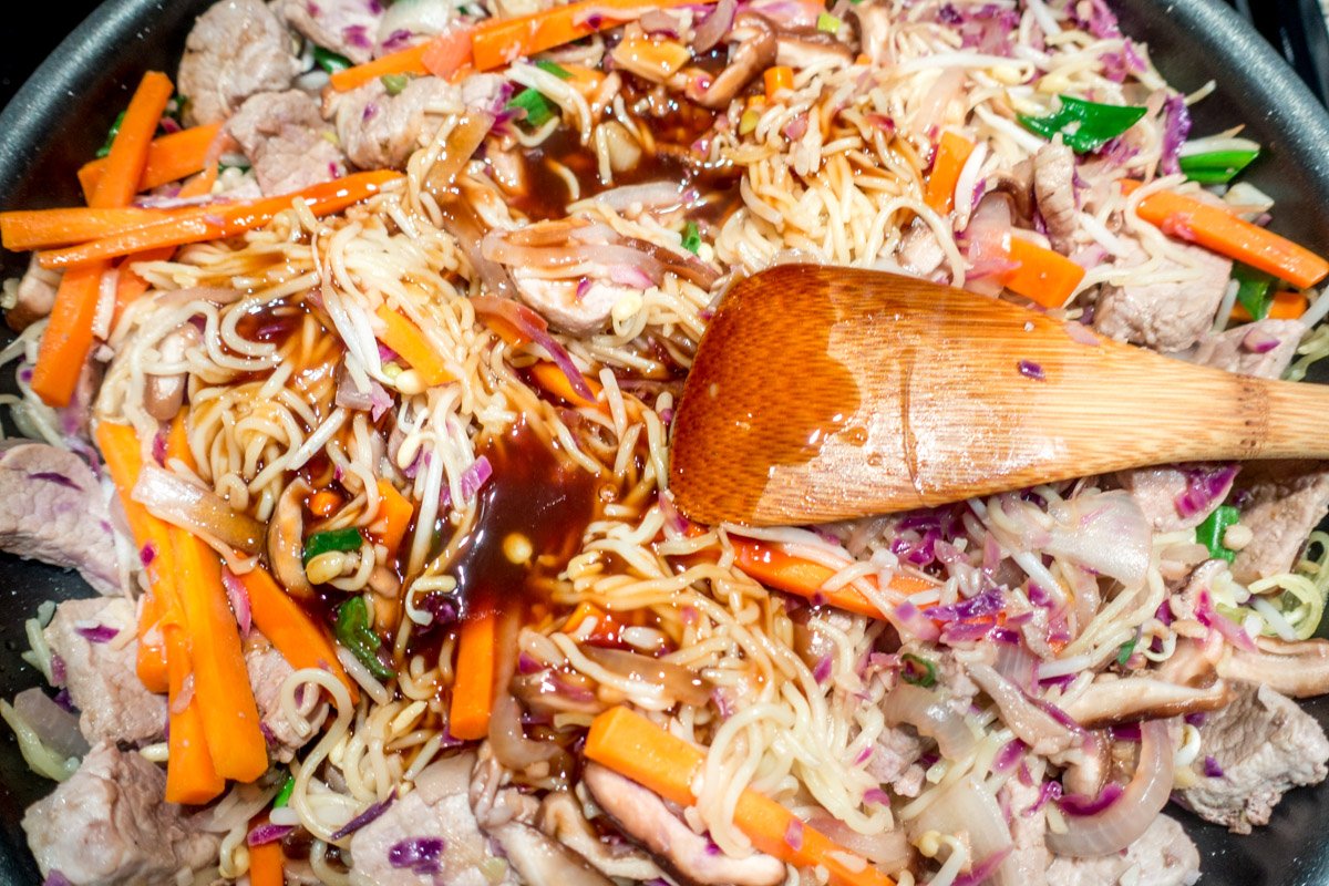 The vegetables, meat, and noodles are topped with a delicious homemade yakisoba sauce before serving