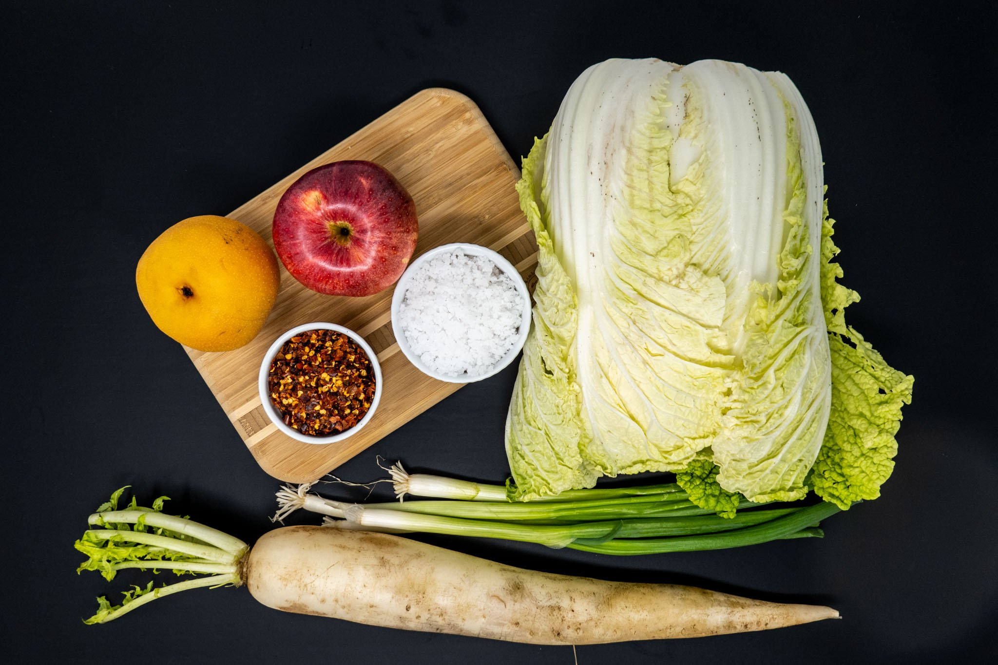 Cabbage, daikon radish, Asian pear, and other ingredients for the Korean kimchee recipe on the table