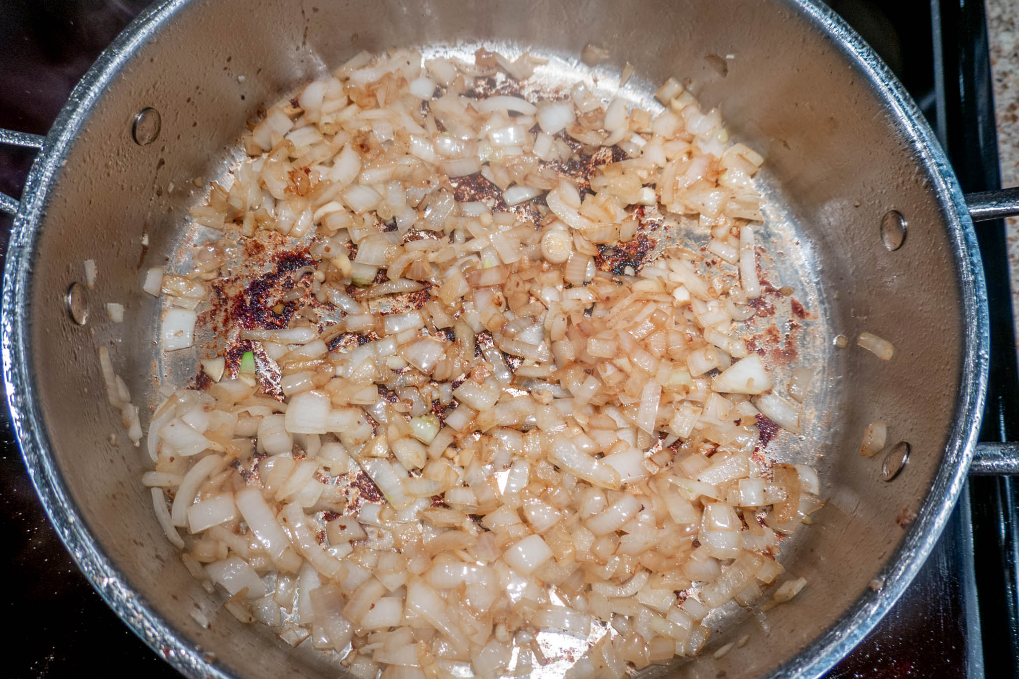 Sauteed onions and garlic in pan for slow cooker stroganoff