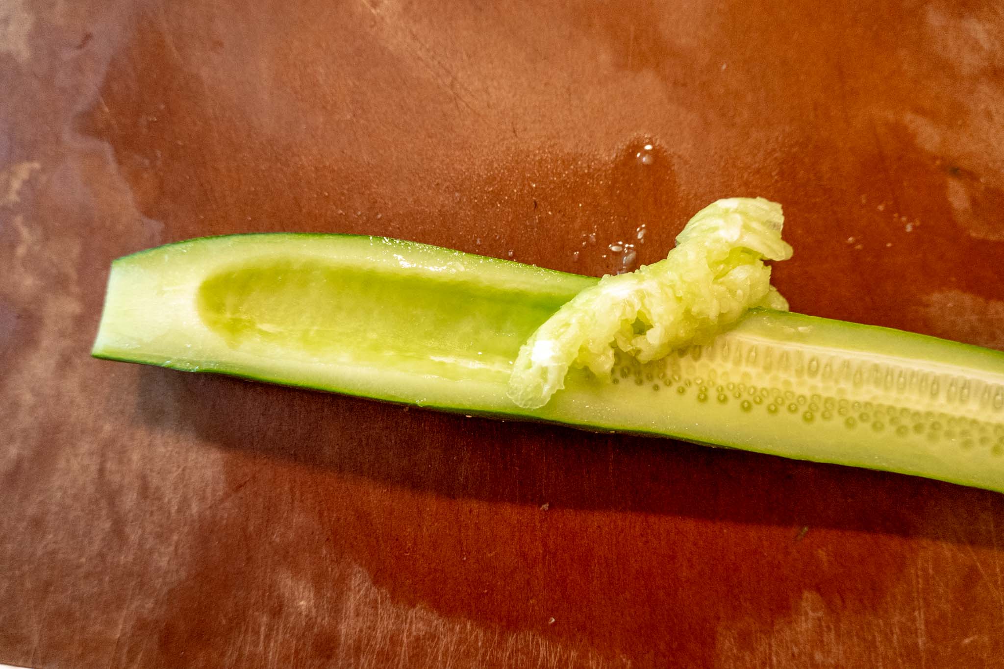 Seeds being removed from a cucumber